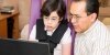 father and child discuss Internet at laptop