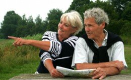 A senior couple reads a map
